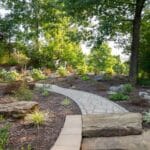 landscaping with native plants with paver sidewalk and natural stone stairs