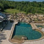 waterfall into rec swim pond with waterslide and paver patio