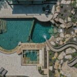 waterfall into rec swim pond with waterslide and paver patio