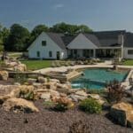 waterfall into rec swim pond with waterslide and paver patio
