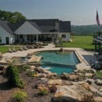 waterfall into rec swim pond with waterslide and paver patio