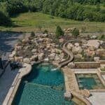 waterfall into rec swim pond with waterslide and paver patio