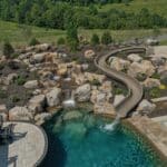 waterfall into rec swim pond with waterslide and paver patio