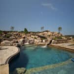 waterfall into rec swim pond with waterslide and paver patio