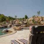 waterfall into rec swim pond with waterslide and paver patio