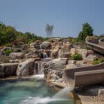 waterfall into rec swim pond with waterslide and paver patio
