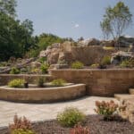 retaining wall planting bed with natural stone and mulch