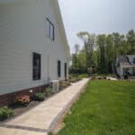 paver sidewalk with planting beds and grass