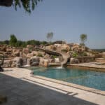 waterfall into rec swim pond with waterslide and paver patio