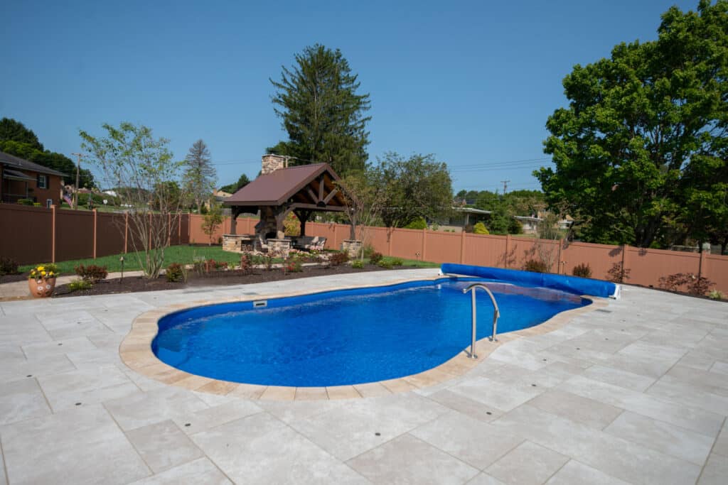 fiberglass swimming pool with paver patio