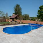 fiberglass swimming pool with paver patio