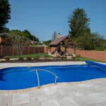 fiberglass swimming pool with paver patio