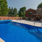 fiberglass swimming pool with paver patio