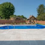 fiberglass swimming pool with paver patio