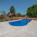 fiberglass swimming pool with paver patio