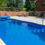 fiberglass swimming pool with paver patio