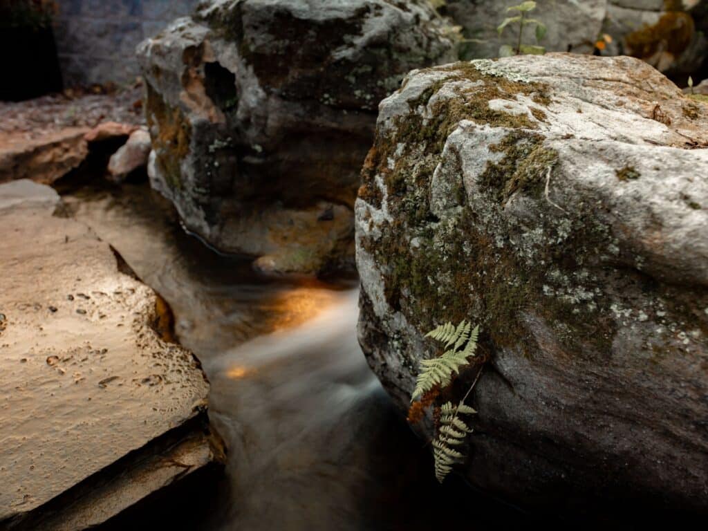 Beautiful Waterfall with Natural Sandstone Mountain Boulders