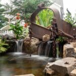 pond with waterfall and landscaping and mountain boulders