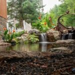pond with waterfall and landscaping and mountain boulders