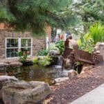 pond with waterfall and landscaping and mountain boulders