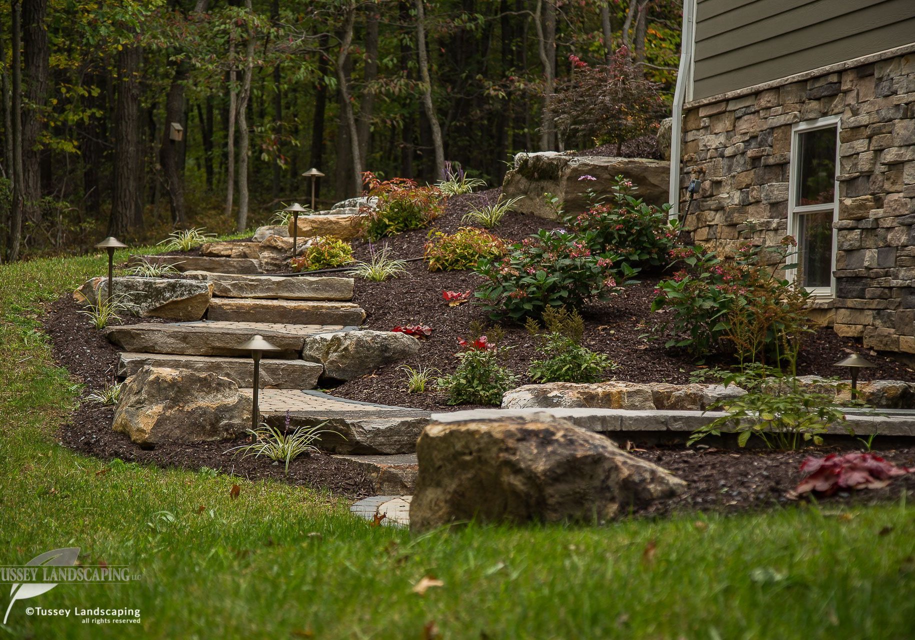 A stone walkway leading up to a house.