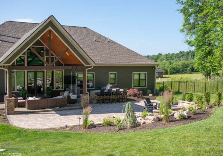 outdoor living space with paver patio, firepit, and water feature