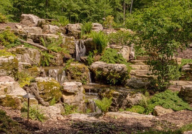 large waterfall with boulders and natural stone stairs