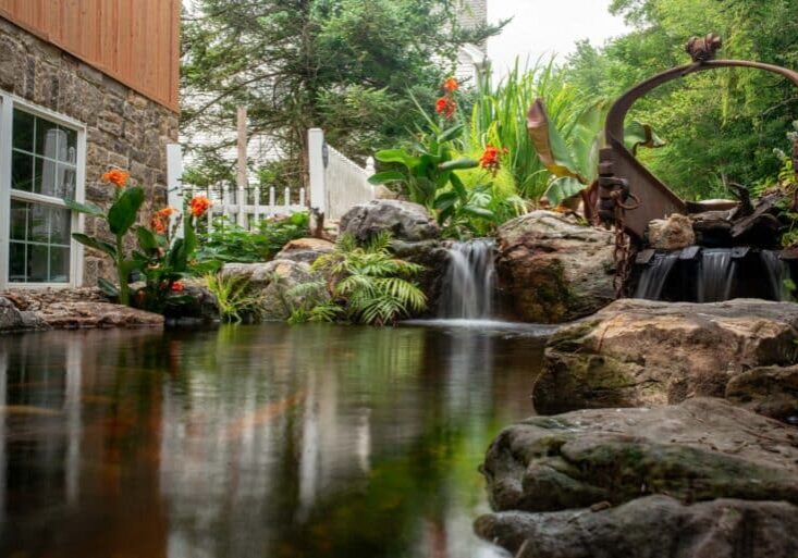 pond with waterfall and landscaping and mountain boulders