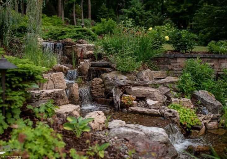 waterfall with pond and landscaping and hardscaping