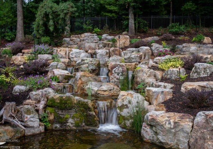 Large waterfall with landscaping and pond