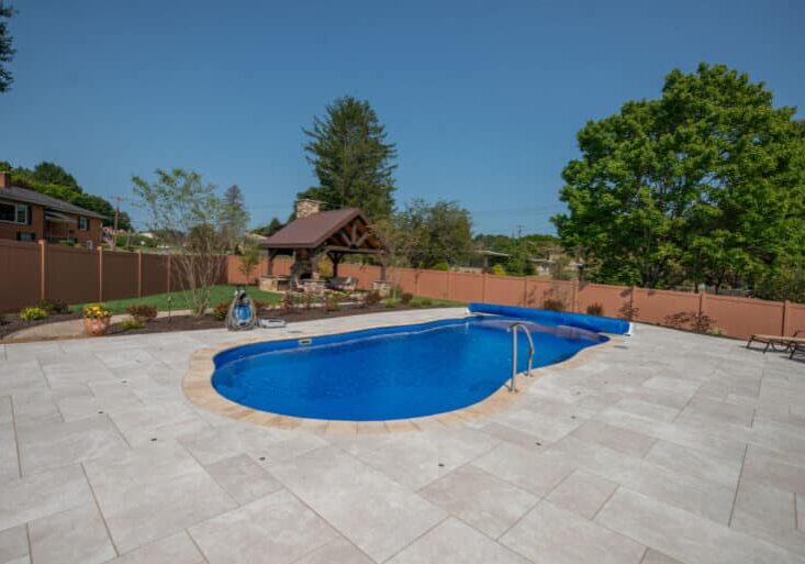 fiberglass swimming pool with paver patio