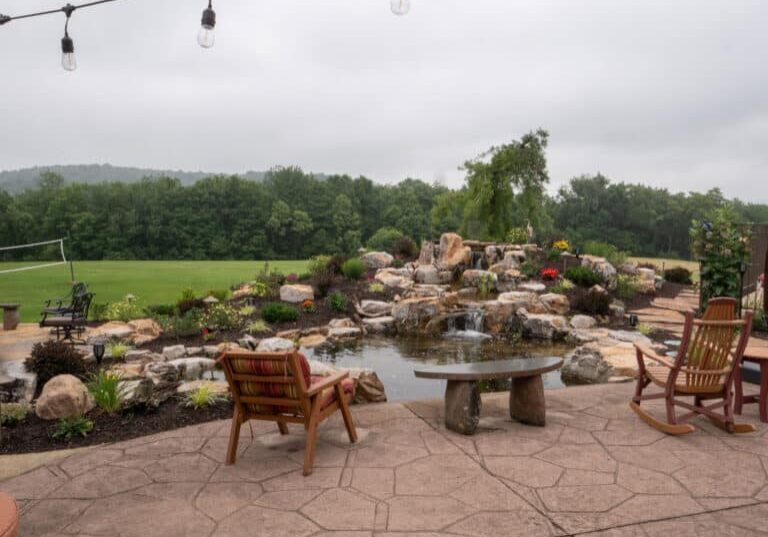 waterfall with koi pond, mountain , boulders, flagstone patio and landscaping