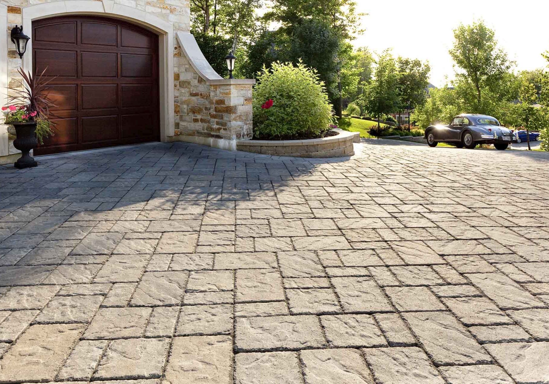 A driveway with stone pavers and a garage.