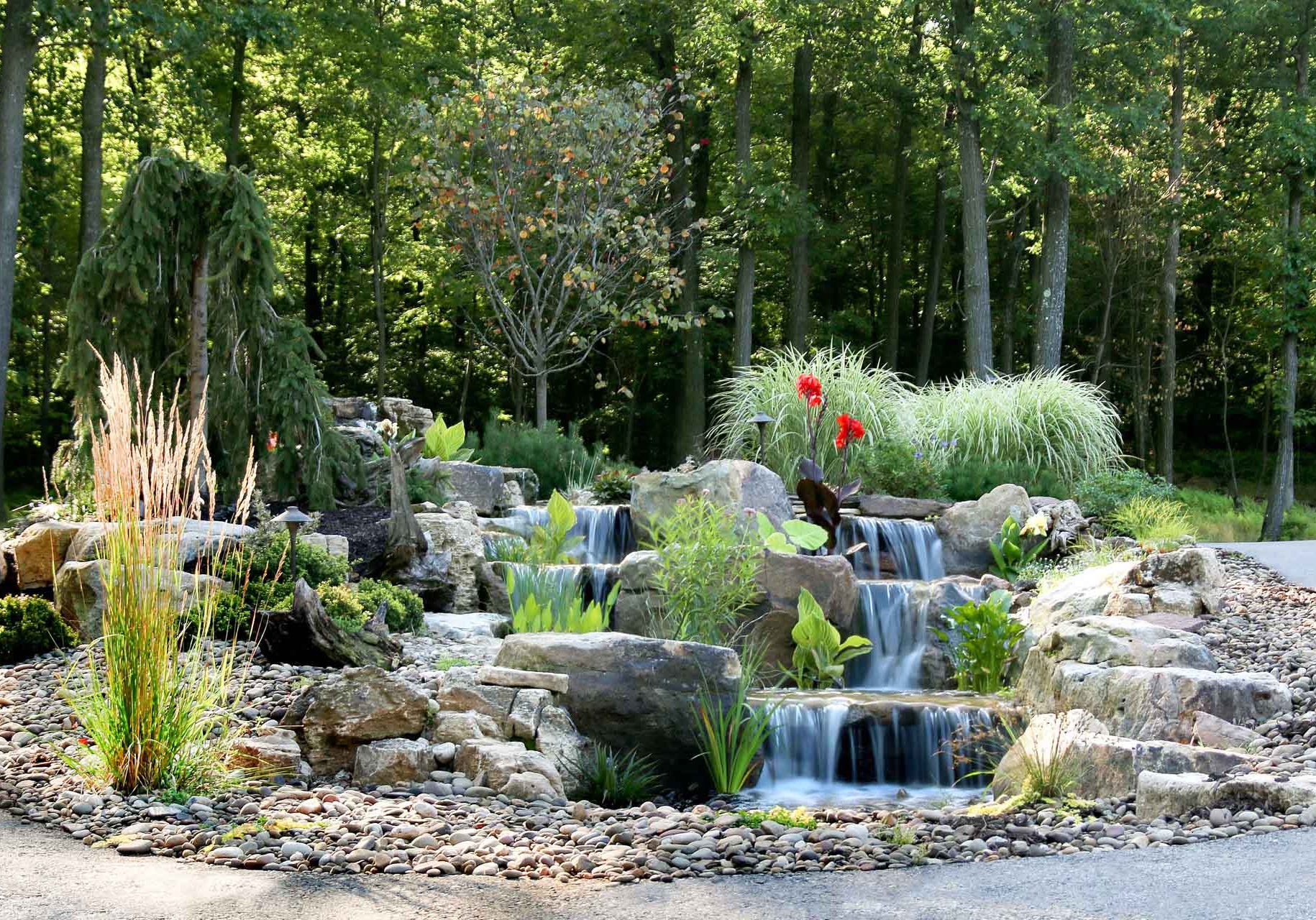 A rock garden with a waterfall in the middle.